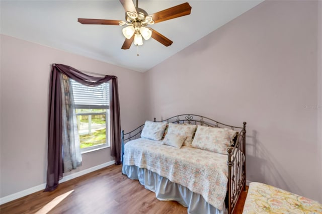 bedroom featuring wood-type flooring, vaulted ceiling, and ceiling fan