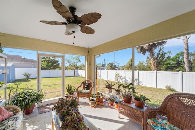 sunroom featuring ceiling fan