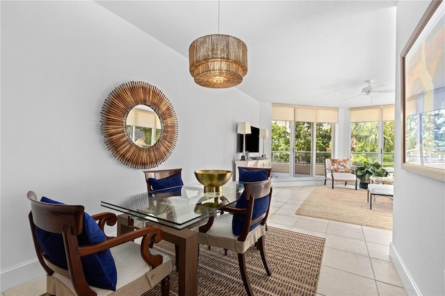 dining room featuring ceiling fan, light tile patterned floors, and a wall of windows