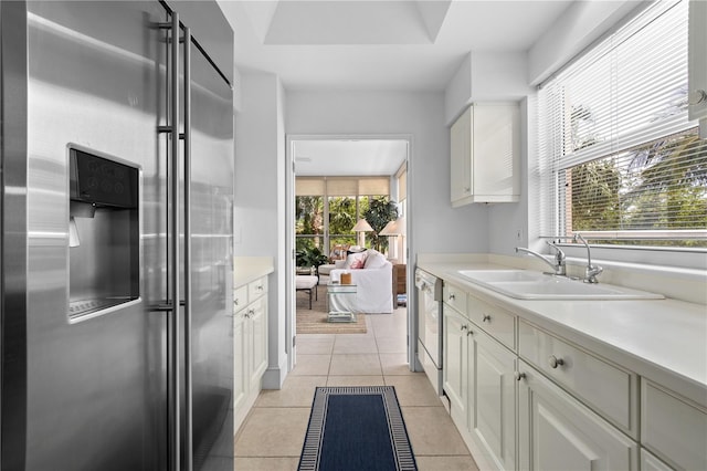 kitchen featuring sink, light tile patterned floors, and stainless steel appliances