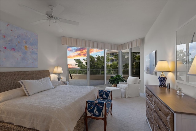 bedroom featuring access to outside, light colored carpet, and ceiling fan