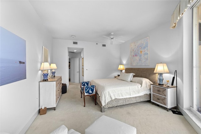 bedroom featuring light carpet and ceiling fan