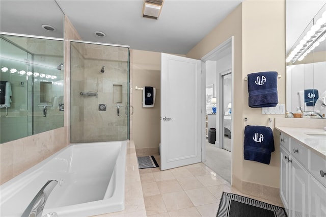 bathroom with tile patterned floors, vanity, and separate shower and tub