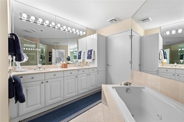 bathroom with tile patterned floors, vanity, and shower with separate bathtub