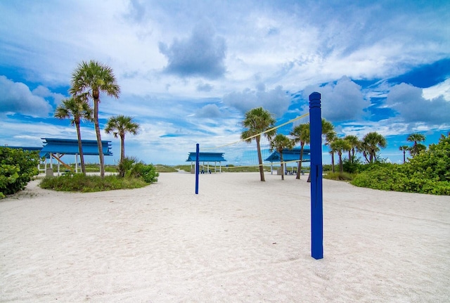 view of home's community featuring volleyball court and a water view