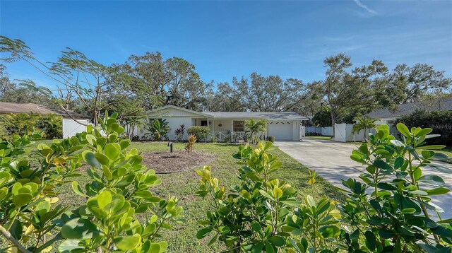 single story home with a porch and a garage