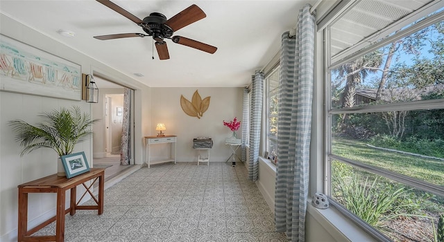 sunroom / solarium with ceiling fan and a healthy amount of sunlight