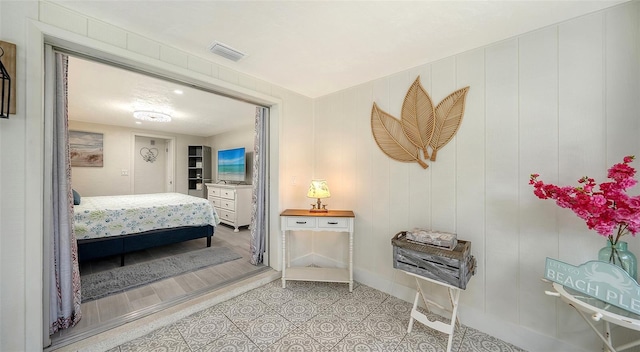 bedroom with light tile patterned floors