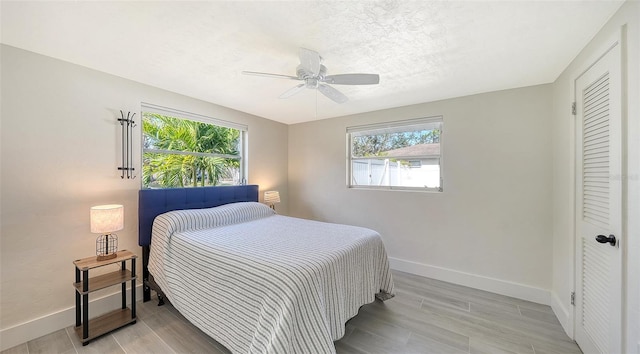 bedroom with ceiling fan and light hardwood / wood-style flooring