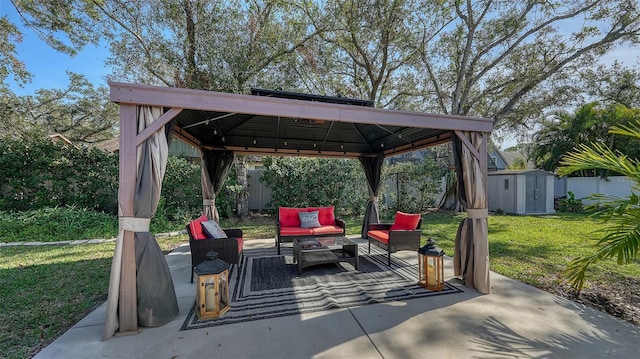 view of patio / terrace featuring outdoor lounge area, a gazebo, and a shed