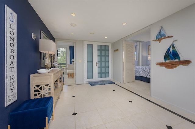 entryway featuring light tile patterned floors and french doors