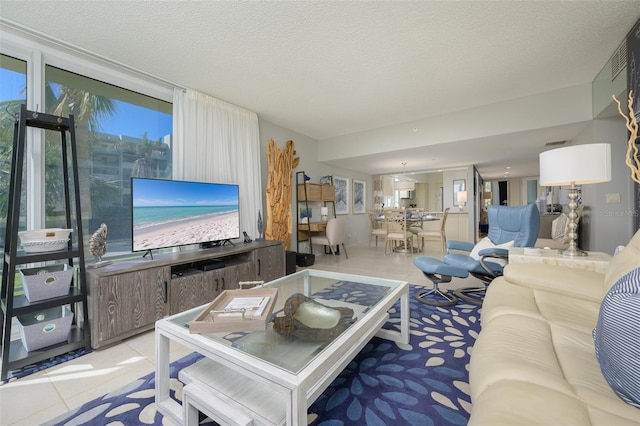 living room with light tile patterned floors and a textured ceiling