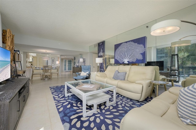 tiled living room featuring a textured ceiling