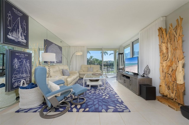 living room featuring light tile patterned flooring and a wall of windows