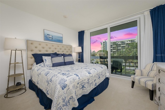 carpeted bedroom featuring floor to ceiling windows and access to outside