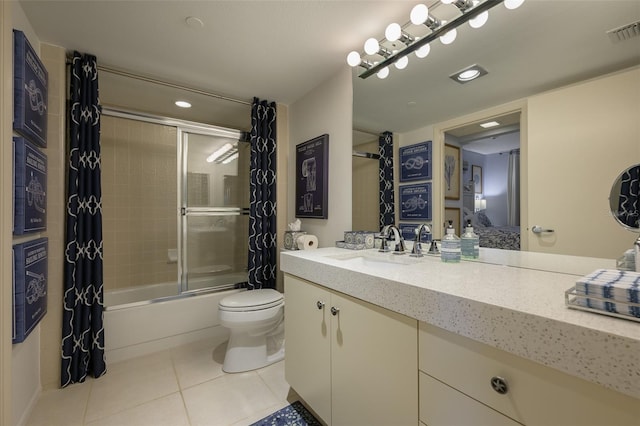 full bathroom featuring tile patterned floors, vanity, toilet, and combined bath / shower with glass door