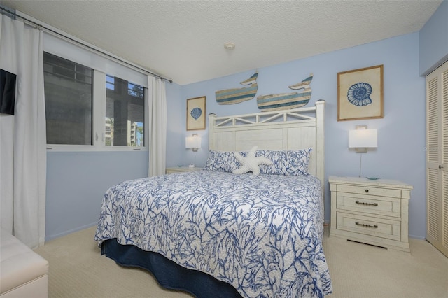 carpeted bedroom with a closet and a textured ceiling