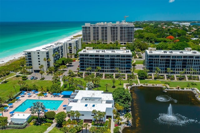 drone / aerial view featuring a water view and a view of the beach