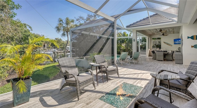 view of patio featuring glass enclosure and ceiling fan