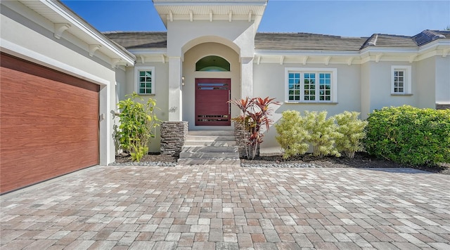 view of exterior entry with a garage