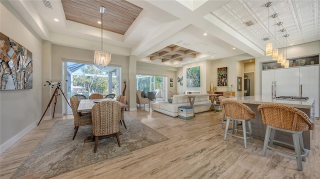 dining area featuring beamed ceiling, a chandelier, and coffered ceiling