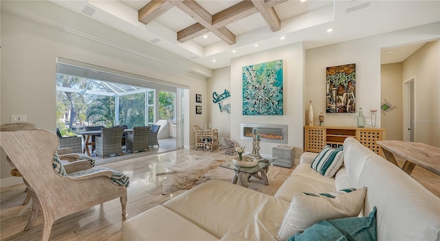 living room with beamed ceiling, a high ceiling, and coffered ceiling