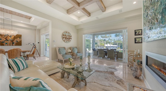 living room featuring beam ceiling, a towering ceiling, coffered ceiling, and an inviting chandelier