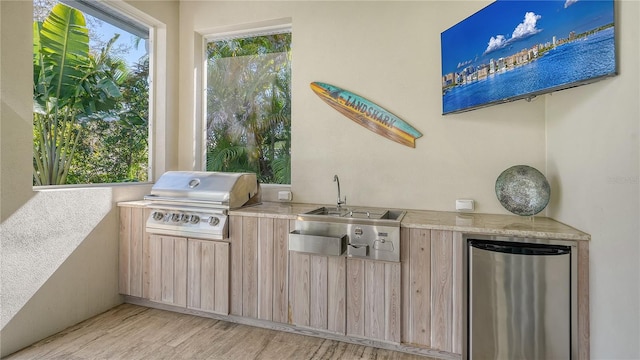 view of patio featuring a grill, exterior kitchen, and sink