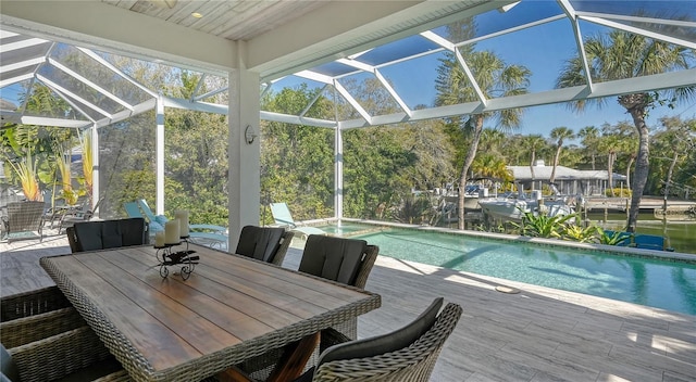 exterior space featuring a lanai, a patio area, and a water view