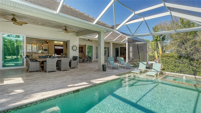 view of swimming pool featuring ceiling fan, a patio, and glass enclosure