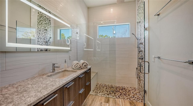 bathroom with vanity, an enclosed shower, and hardwood / wood-style flooring