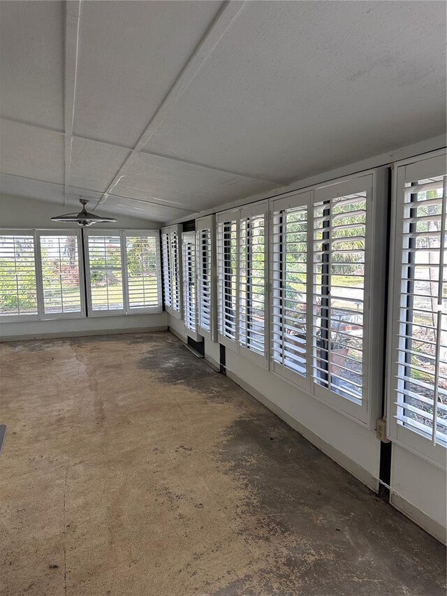 unfurnished sunroom with ceiling fan