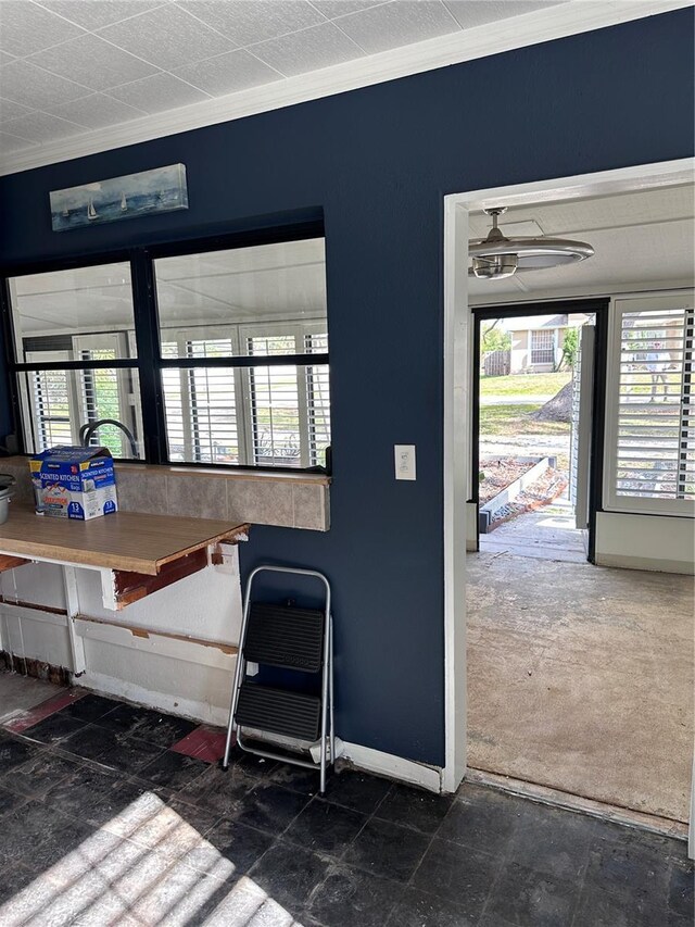 misc room featuring a wealth of natural light, ornamental molding, and ceiling fan