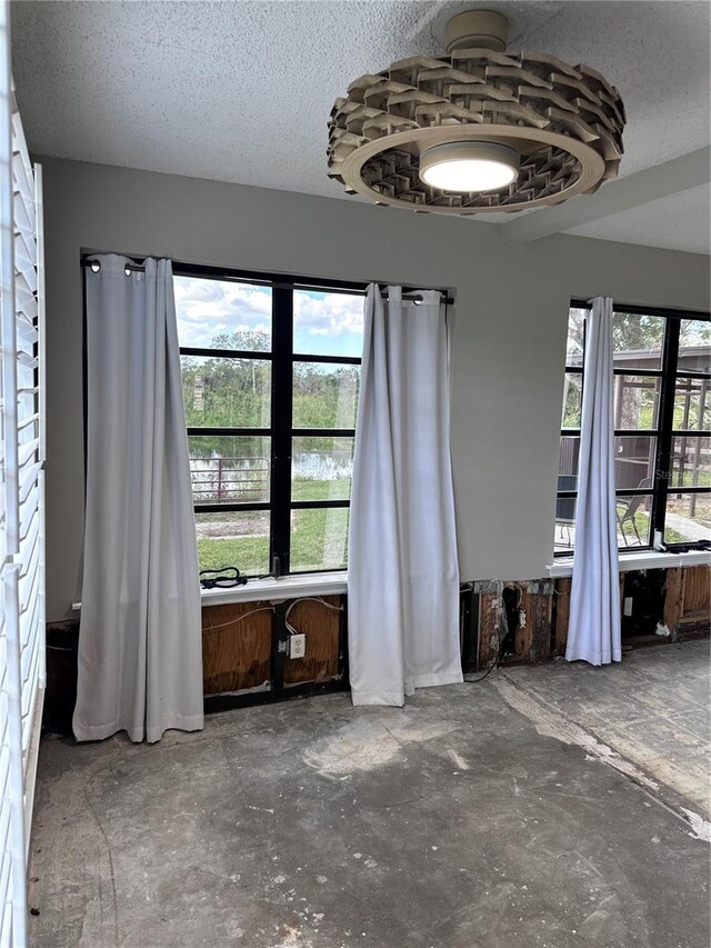 unfurnished room featuring a textured ceiling