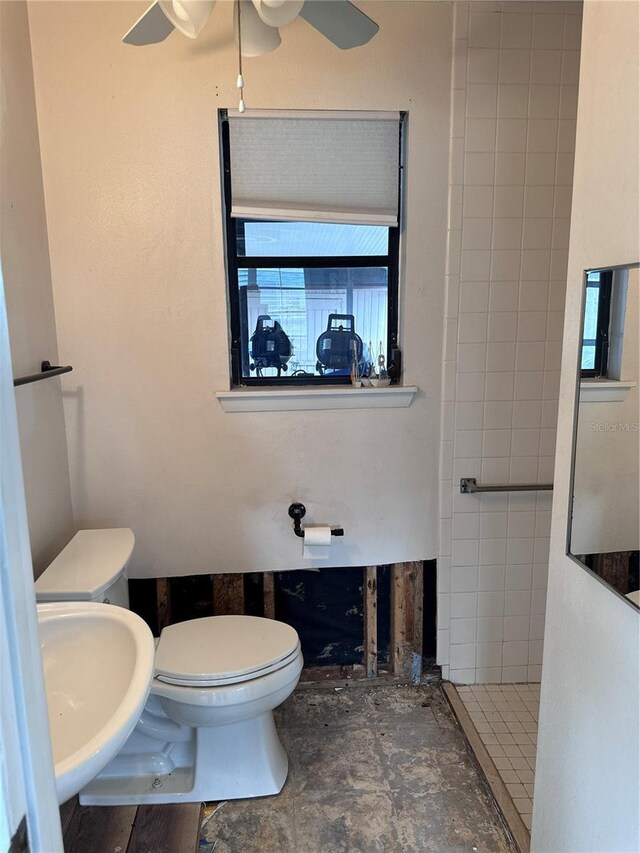 bathroom featuring toilet, ceiling fan, and sink