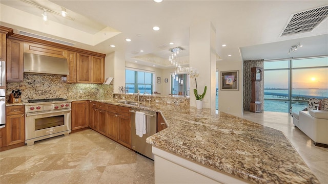 kitchen featuring a water view, kitchen peninsula, stainless steel appliances, and extractor fan