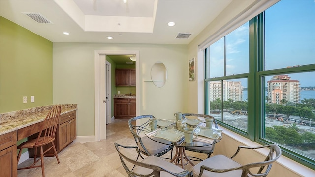 dining room featuring a tray ceiling