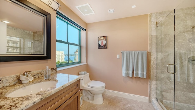 bathroom with tile patterned floors, a shower with door, vanity, and toilet