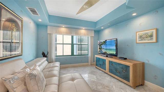 living room with a tray ceiling