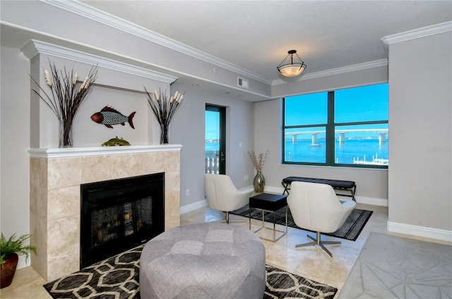 living room with a tile fireplace, a healthy amount of sunlight, and ornamental molding