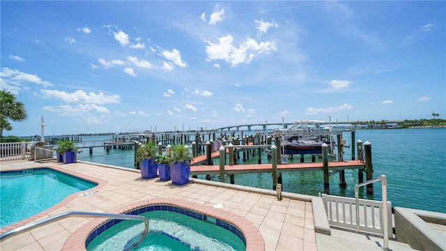 dock area featuring a water view and a pool with hot tub