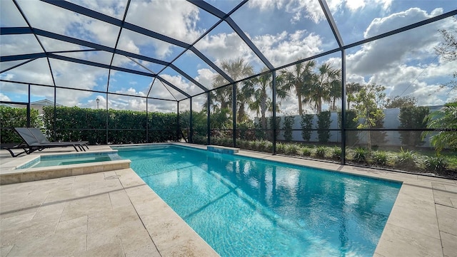 view of pool featuring a lanai, a patio area, and an in ground hot tub