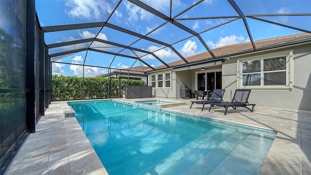 view of pool featuring an in ground hot tub, a patio, ceiling fan, and a lanai