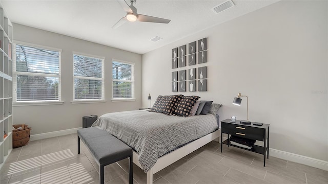 bedroom featuring ceiling fan and tile patterned flooring