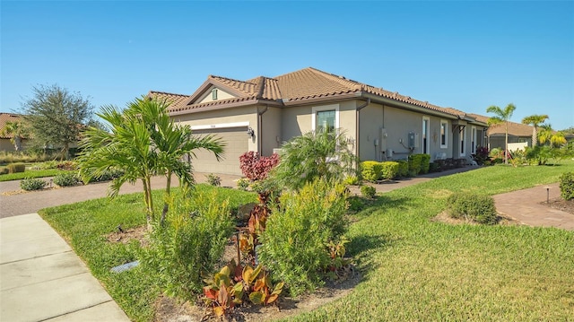 view of side of property featuring a yard and a garage