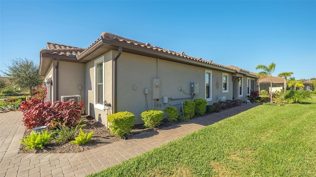 view of property exterior featuring a lawn