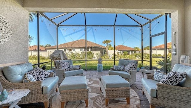 view of patio with an outdoor living space and glass enclosure