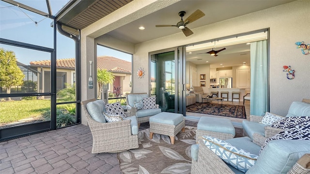 sunroom featuring ceiling fan and a healthy amount of sunlight