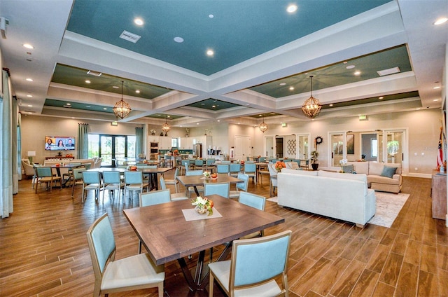 dining area featuring hardwood / wood-style flooring and an inviting chandelier