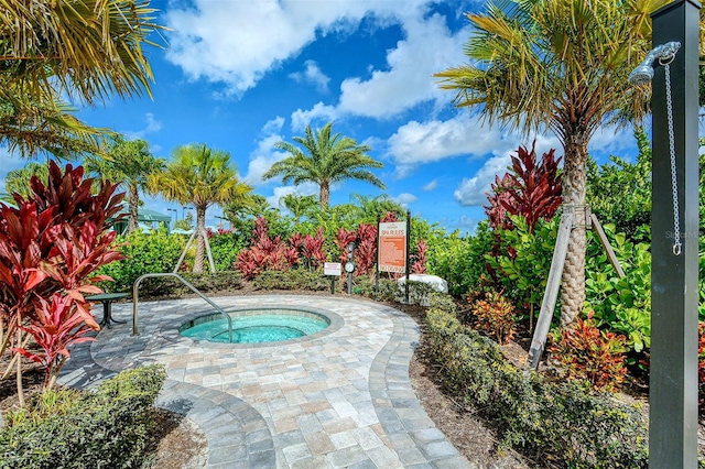 view of swimming pool with a hot tub